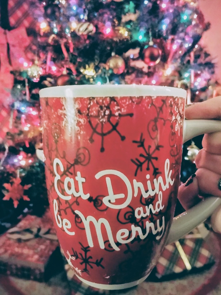 Eat Drink and Be Merry Tea Cup with Christmas Tree in background