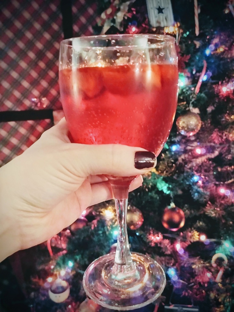Strawberry mocktail in wine glass in front of tree